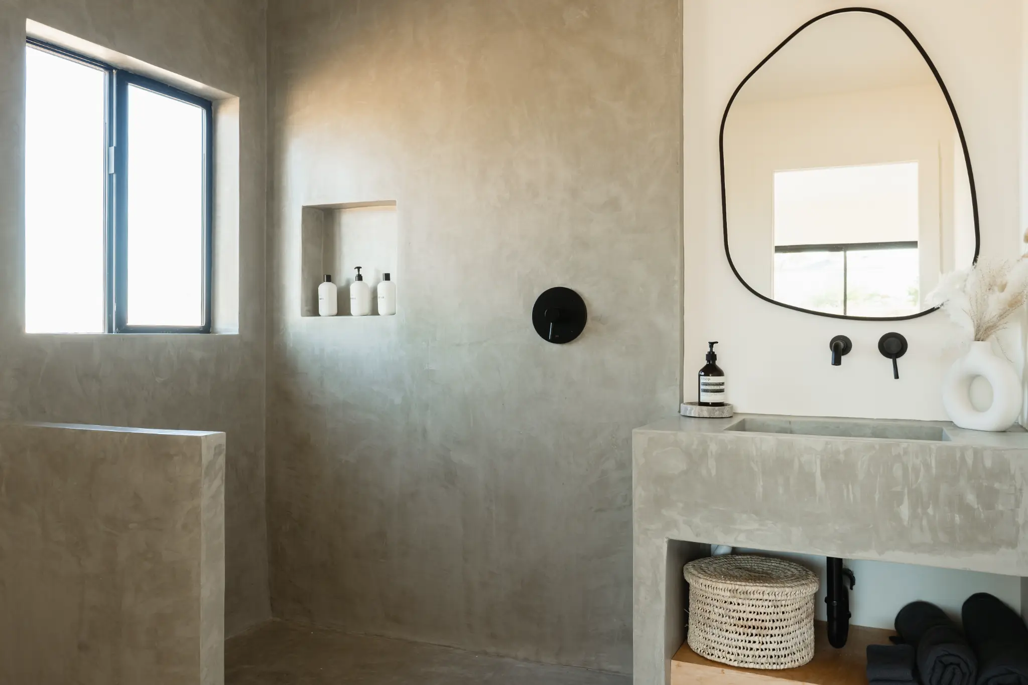 Bedroom Three ensuite — grey concrete walls and black fixtures