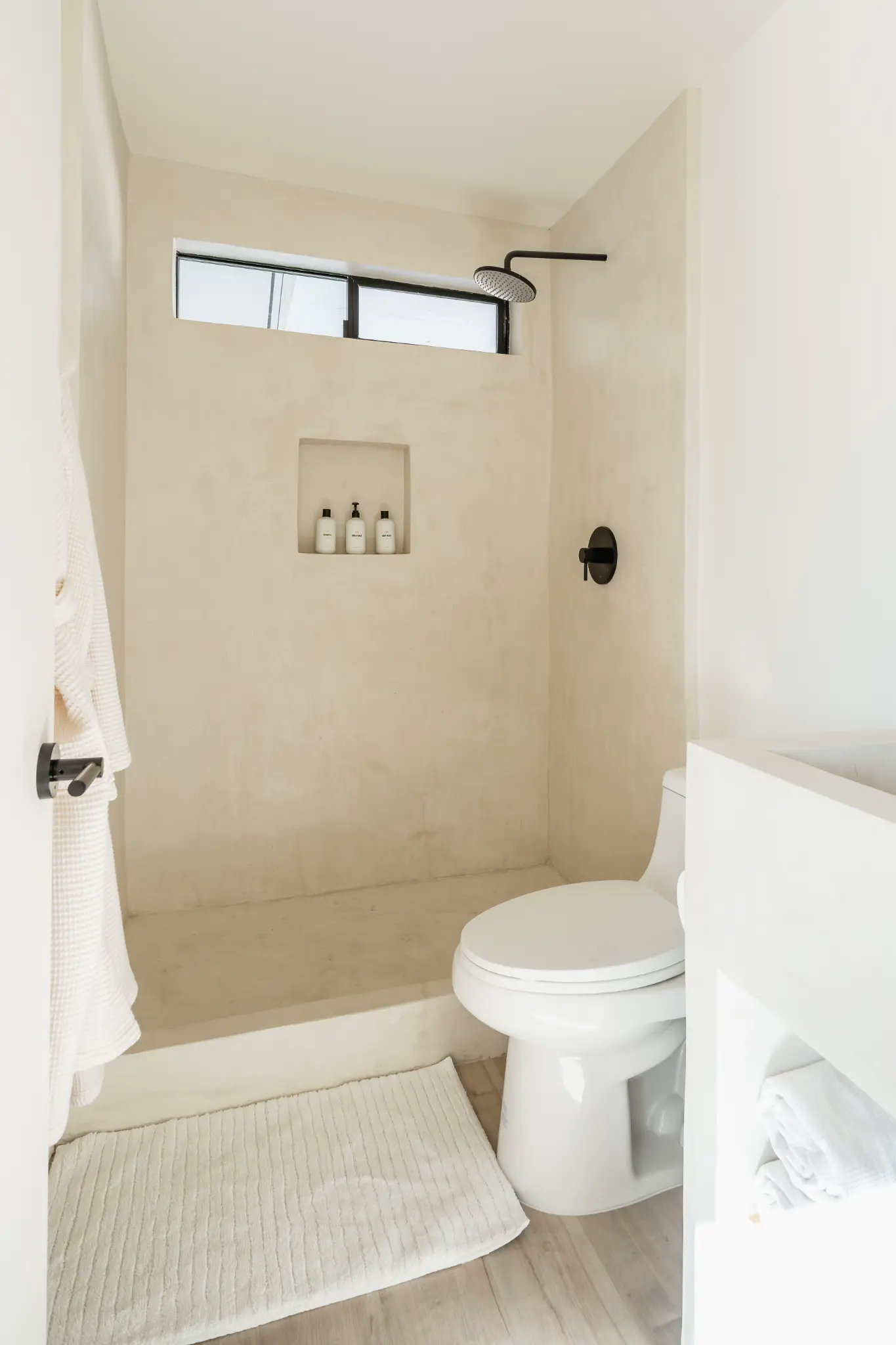 Primary Suite bath — bone plaster shower with rain head