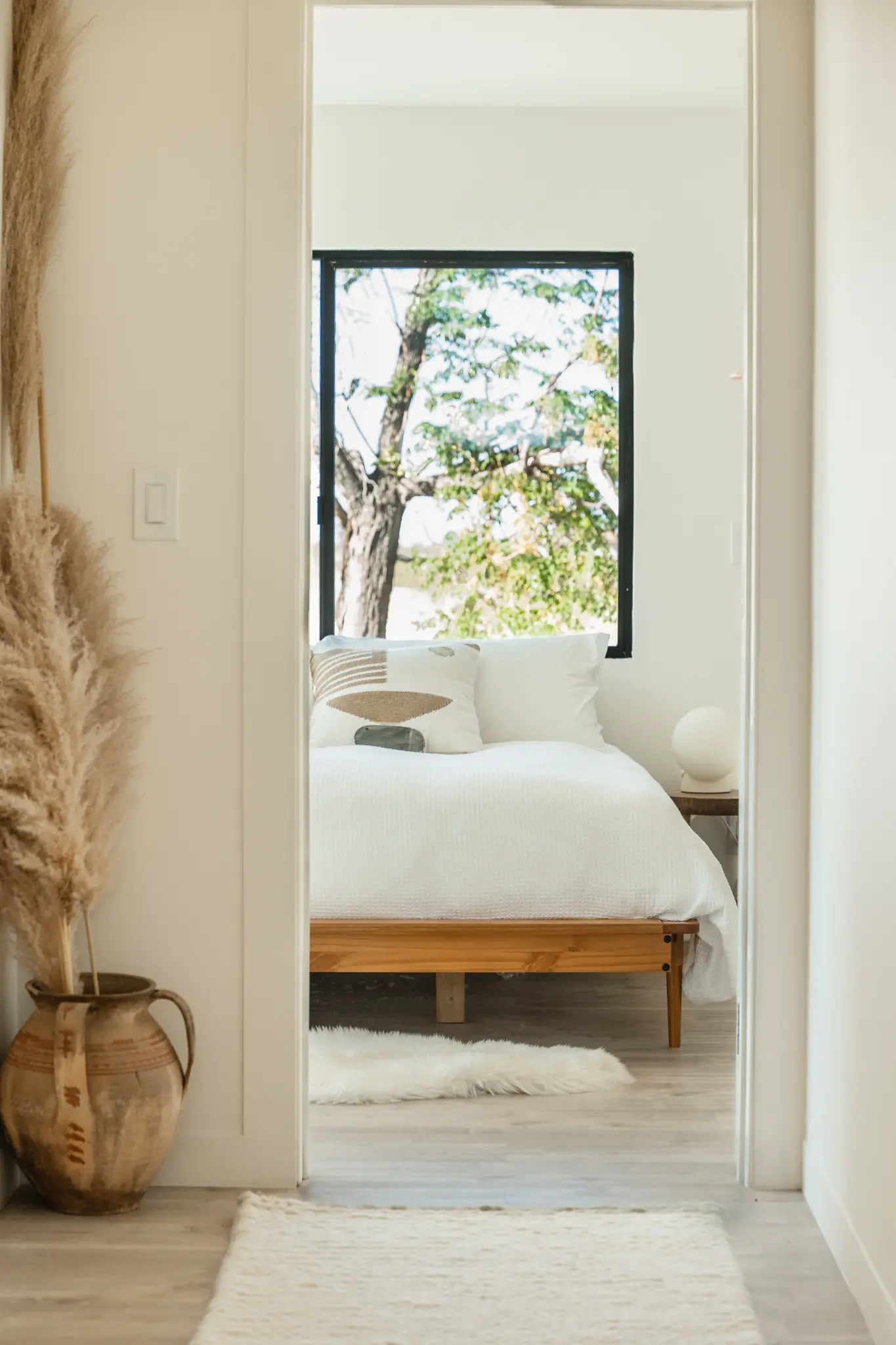 Second bedroom detail — warm tones and natural materials